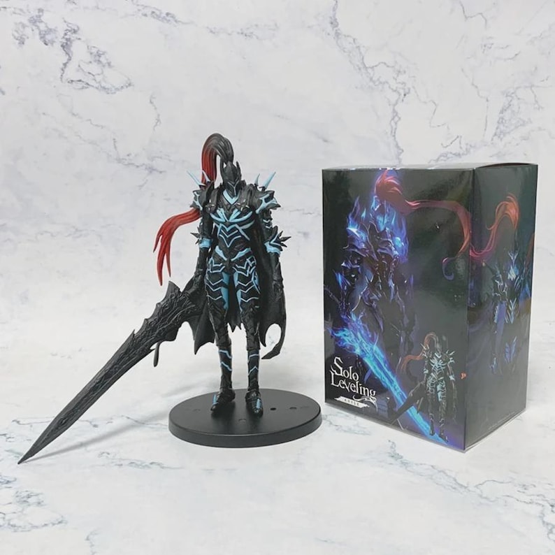 May include: A black and blue action figure of a character with a large sword, cape, and spiky armor, standing on a black base. A matching box with the words "Solo Leveling" is next to the figure.