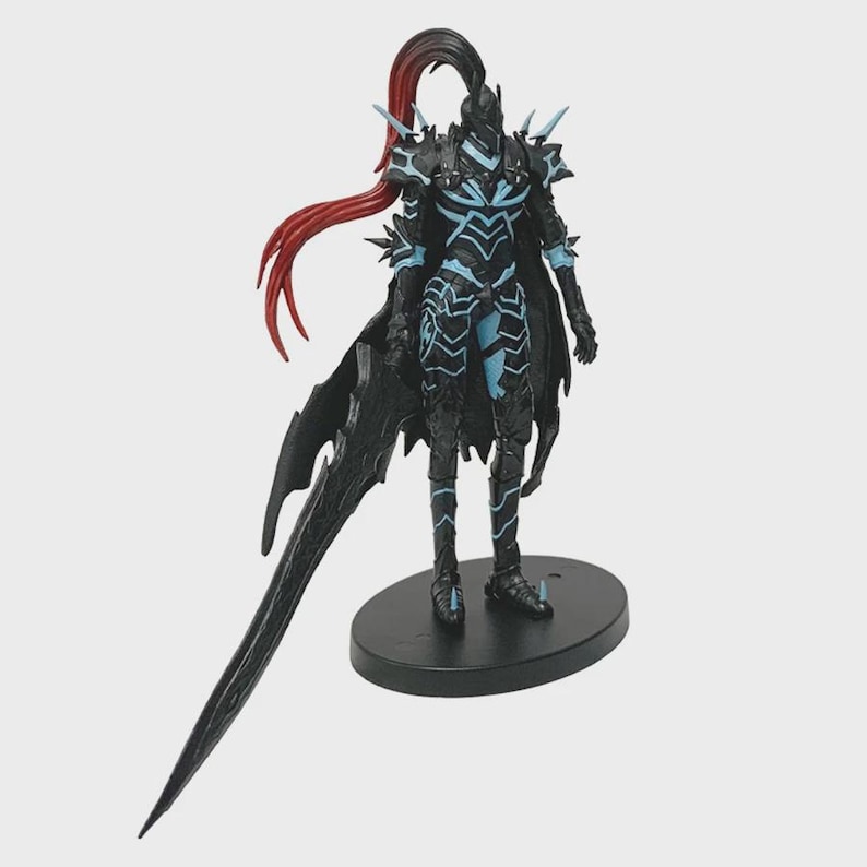 May include: A detailed figurine of a warrior in black armor with blue accents. The figure has a long, flowing red ponytail and is holding a large, black sword. The figurine stands on a black oval base.