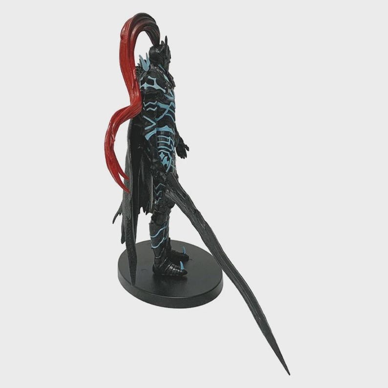 May include: A black figurine of a warrior in armor, with blue accents and a red ponytail. The warrior is holding a long, curved sword and stands on a black circular base. The figurine is a collectible item.
