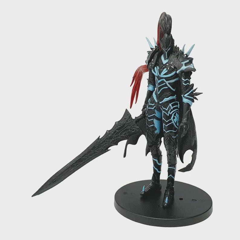 May include: A black action figure of a warrior in armor, holding a large sword. The figure has blue accents and red hair-like details. It stands on a black circular base, showcasing a detailed design.