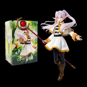 May include: A figurine of a female anime character with long lavender hair, pointy ears, and a white and gold outfit. She holds a red staff with a large red orb. A box with a matching image is to the left.