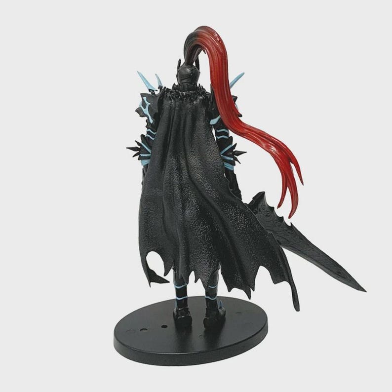 May include: A black action figure of a warrior with a long, flowing red ponytail. The figure is wearing black armor with blue accents and a long cape. It is standing on a black oval base, and holding a black sword.