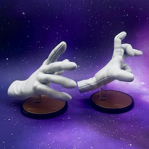 May include: Two white, gloved hands, posed as if interacting, are displayed on separate circular bases. The bases have a gold top and a black rim. The background is a purple and blue gradient with white specks.