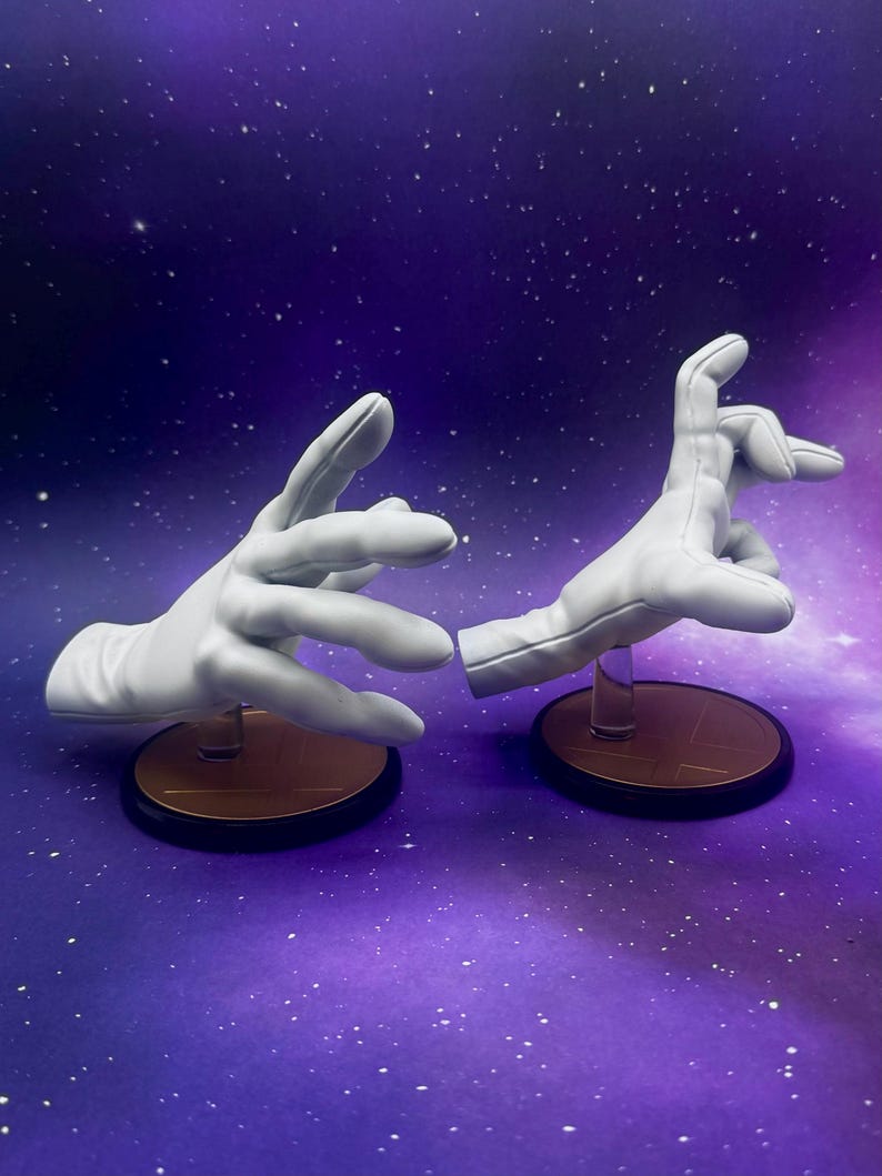 May include: Two white, gloved hands, posed as if interacting, are displayed on separate circular bases. The bases have a gold top and a black rim. The background is a purple and blue gradient with white specks.