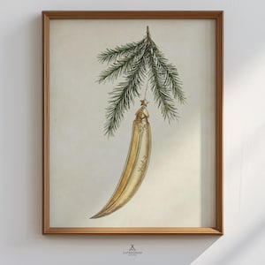 May include: A framed vintage-style print featuring a gold Christmas ornament hanging from a pine branch. The ornament is elongated with intricate detailing, suspended by a string with a star. The artwork is set against a cream-colored background.