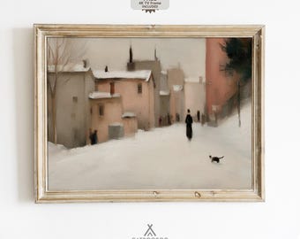 May include: Framed vintage-style artwork depicting a snowy street scene with buildings in muted tones of pink, beige, and gray. A figure in black walks down the street, with a small black cat. The frame is a light, distressed gold color.