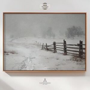 May include: A framed landscape print depicting a snowy field with a wooden fence and trees in the background. The artwork is in a wooden frame and includes the text "FREE 4K TV Frame Included". The artist's name, CATROOBOO ART TRIBE, is at the bottom.