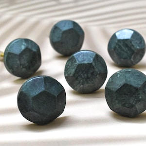 May include: Six dark green marble cabinet knobs with a faceted design.