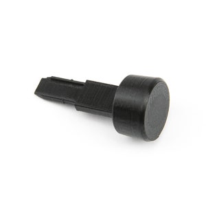 May include: A black plastic tool with a flat, pointed tip and a round, black knob on the other end.