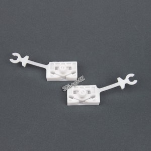 Set of window regulator repair clips for front left and right sides, compatible with Alfa Romeo 147, displaying the clips' robust design and suitability for window mechanism repair.
