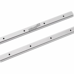 May include: Two silver-colored metal rails with multiple evenly spaced holes. The rails are rectangular with a slightly raised center. The text "3DLogoGZ" is printed on one of the rails. The rails are set against a white background.