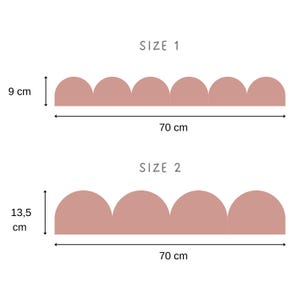 May include: Two decorative wall border designs in a soft pink hue. Size 1 is 9 cm high and 70 cm wide. Size 2 is 13.5 cm high and 70 cm wide. The borders have a scalloped edge design. The text "SIZE 1" and "SIZE 2" are above each design.