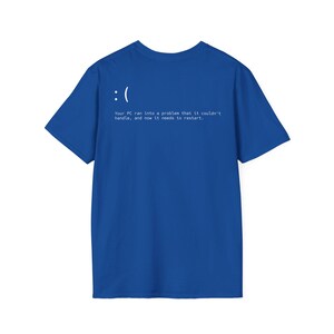 May include: Royal blue t-shirt with white text and a sad face graphic. The text reads: "Your PC ran into a problem that it couldn't handle, and now it needs to restart."
