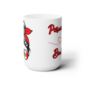 May include: White ceramic mug with a red and white illustration of a woman with a red bandana and a Peruvian flag on her sunglasses. The text "Peruvian Bombshell" is written in red on the mug.