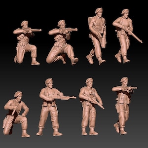 May include: Nine plastic figurines of soldiers wearing berets and holding rifles. The soldiers are in various poses, some standing, some kneeling, and some aiming their rifles.