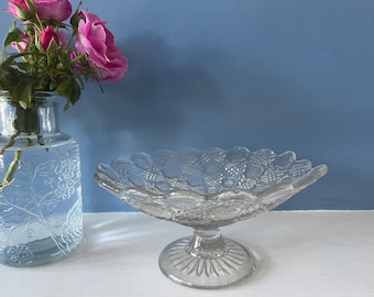 Beautiful vintage glass cake stand on a decorative glass pedestal.