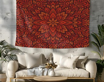 Puede incluir: Un tapiz mandala rojo y naranja con intrincados patrones florales. El tapiz está colgado en una pared gris sobre un sofá blanco.