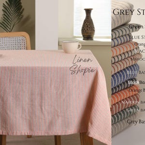 May include: A pink and white striped tablecloth with the text "Linen Shopie" on it. The tablecloth is on a table with a chair and a cup on it. The image also shows a sample of different coloured striped fabrics with the text "GREY STRIPE" at the top.
