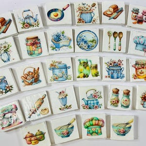 May include: A collection of square, decorative tiles featuring watercolor illustrations of kitchen-themed items. Images include a teapot, frying pan, bread, jars, flowers, and cooking utensils. The tiles are arranged on a white surface.
