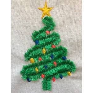 May include: Embroidered Christmas tree with a yellow star on top. The green tree is decorated with colorful lights in red, blue, and yellow. The embroidery is on a beige fabric background.