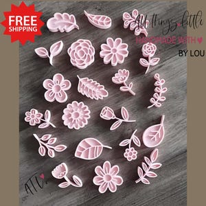 May include: Pink floral and leaf-shaped craft supplies. The image shows various flower and leaf designs, including roses, daisies, and other botanical shapes. The text "All things little, handmade with love by Lou" is visible.