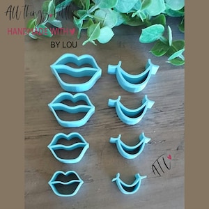 May include: A set of eight light blue plastic cookie cutters arranged in two columns. The left column features four full lip shapes in descending sizes, while the right column shows four crescent-shaped smile cutters. Text reads All things little HANDMADE WITH BY LOU and ATL.
