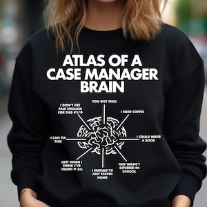 May include: Black sweatshirt with a white graphic of a brain with text around it that says "Atlas of a Case Manager Brain". The text around the brain includes phrases like "I don't get paid enough for this", "You got this", "I need coffee", "I can fix this", "I could write a book", "Just when I think I've heard it all", "I should've just stayed home", and "This wasn't covered in school".