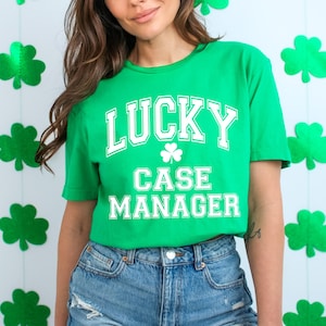 May include: A green t-shirt with white text that reads "LUCKY CASE MANAGER" and a shamrock graphic.