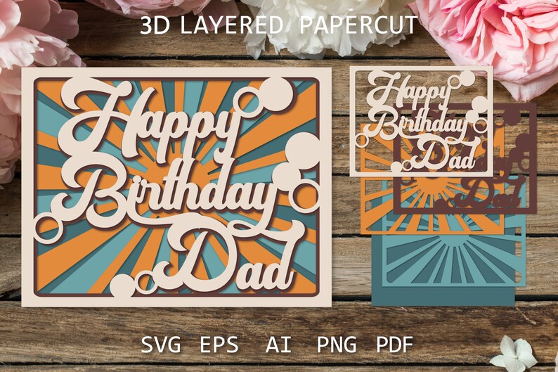 May include: A 3D layered papercut card with a sunburst design and the text "Happy Birthday Dad". The card is made of beige cardstock with orange and blue accents.