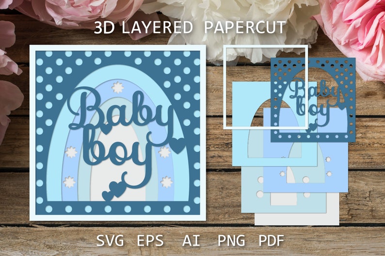 May include: A 3D layered papercut design featuring a rainbow with the words "Baby Boy" in a blue and white color scheme. The design is perfect for a baby shower or nursery decoration.