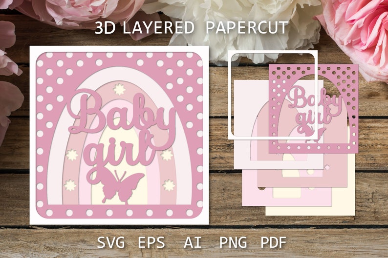 May include: A pink and white layered papercut design with a rainbow and the text "Baby girl" in a pink script font. A butterfly is in the center of the rainbow. The design is on a white background with pink polka dots.