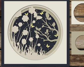 May include: A layered paper cut design featuring a circle with a dark blue background and white silhouettes of flowers, leaves, and butterflies. The design is framed in a black frame with the words "SVG EPS AI PNG PDF" at the bottom.