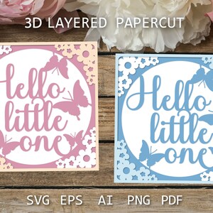 May include: Two 3D layered papercut designs with the text "Hello little one" in white. The design on the left is pink with white flowers and butterflies. The design on the right is blue with white flowers and butterflies.