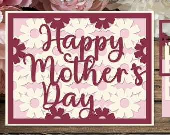 May include: A 3D layered papercraft card with a burgundy frame and white flowers. The card says "Happy Mother's Day" in a burgundy script font.