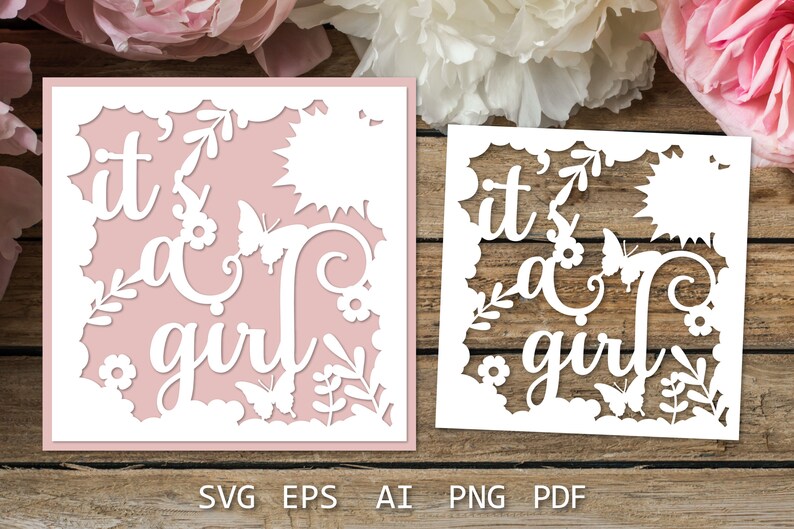 May include: A white paper cut-out design with the text "it's a girl" surrounded by flowers and butterflies. The design is on a pink background.