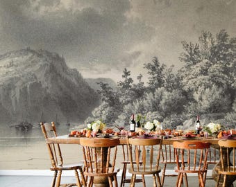 May include: A dining room scene featuring a large wooden table set for a meal, with wooden chairs. The background is a black and white mural of a landscape with a mountain, trees, and a body of water. The table is set with food, flowers, and wine bottles.