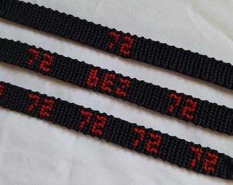 May include: Three black woven friendship bracelets featuring the number 72 stitched in red thread. The top bracelet displays the number 72 once, the middle bracelet shows the number 72 twice, and the bottom bracelet displays the number 72 three times.