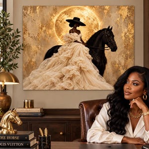 May include: A rectangular wall art print featuring a person in a wide-brimmed black hat and a voluminous, layered cream-colored gown riding a black horse. The background displays a large, glowing golden moon set against a textured, metallic gold backdrop.