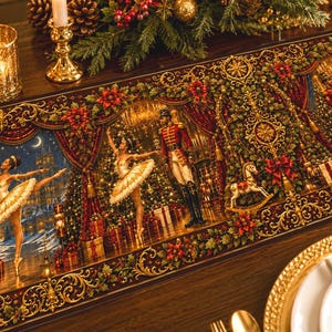 May include: A rectangular table runner featuring a detailed Christmas scene with ballerinas in white tutus, a nutcracker soldier, a rocking horse, and wrapped gifts, all framed by ornate gold scrollwork, red poinsettias, and evergreen foliage.