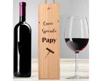 May include: Wooden wine box with a bottle of red wine and a wine glass. The box is engraved with the text "Cuvée Spéciale Papy" and a corkscrew.