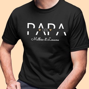 Pode incluir: Camiseta preta com texto branco que diz "Papa Ch&eacute;ri" com dois cora&ccedil;&otilde;es dourados e "Math&eacute;o et Louane" em it&aacute;lico.