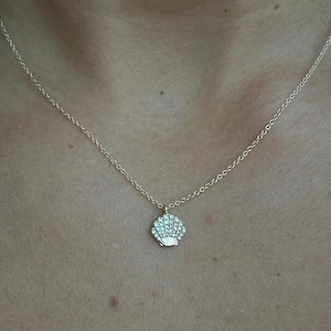 sea shell diamond necklace 14k gold hanging with a loop.