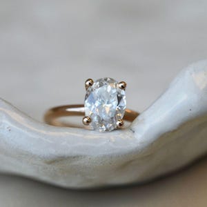 Lab diamond oval ring with diamonds around the crown 14K gold