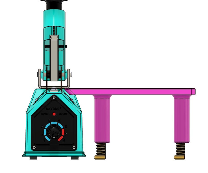 May include: A turquoise and black heat press with a pink platform and two adjustable legs. The heat press has a temperature control knob and a red light indicator. The text "RAYDEN" is printed on the front of the heat press.