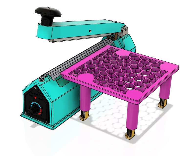 May include: A teal and black heat sealer with a pink honeycomb-patterned platform. The platform has four adjustable legs.