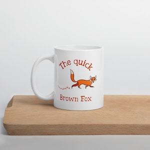 May include: White ceramic mug with a brown fox illustration and the text "The quick Brown Fox".