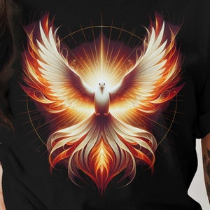 May include: A black t-shirt featuring a graphic of a white dove with orange and yellow flames. The dove is surrounded by a circle of light.