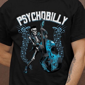 May include: Black t-shirt with a graphic of a skeleton playing a bass guitar. The graphic is in blue and white and includes musical notes. The text "PSYCHOBILLY" is printed in white above the graphic.