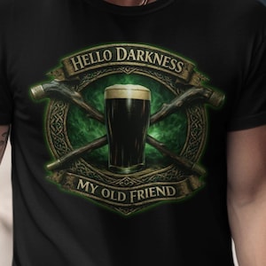 May include: Black t-shirt featuring a graphic with a pint of dark beer, crossed axes, and the text "Hello Darkness My Old Friend" in a green and gold design. The shirt is a classic crew neck.