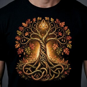 May include: A black t-shirt featuring a graphic print of a large, gnarled tree with intertwined roots and branches. The tree is adorned with autumn-colored leaves and acorns, and it displays two triquetra symbols in a warm, glowing light.